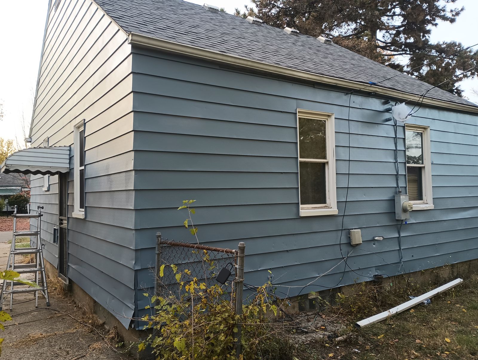 Finished blue house exterior, side angle