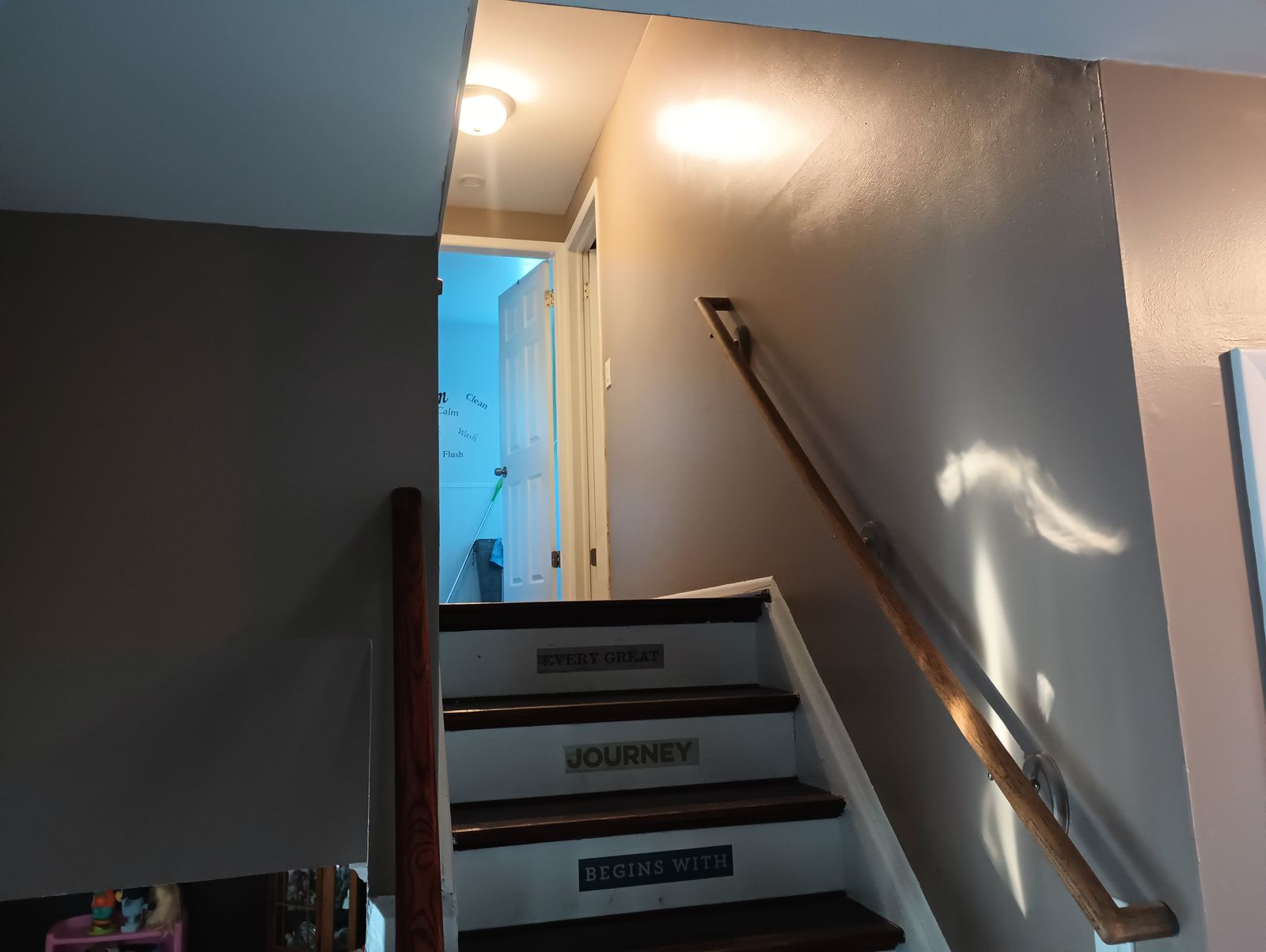 Stairway after repaint, warm brown walls with decorative step decals