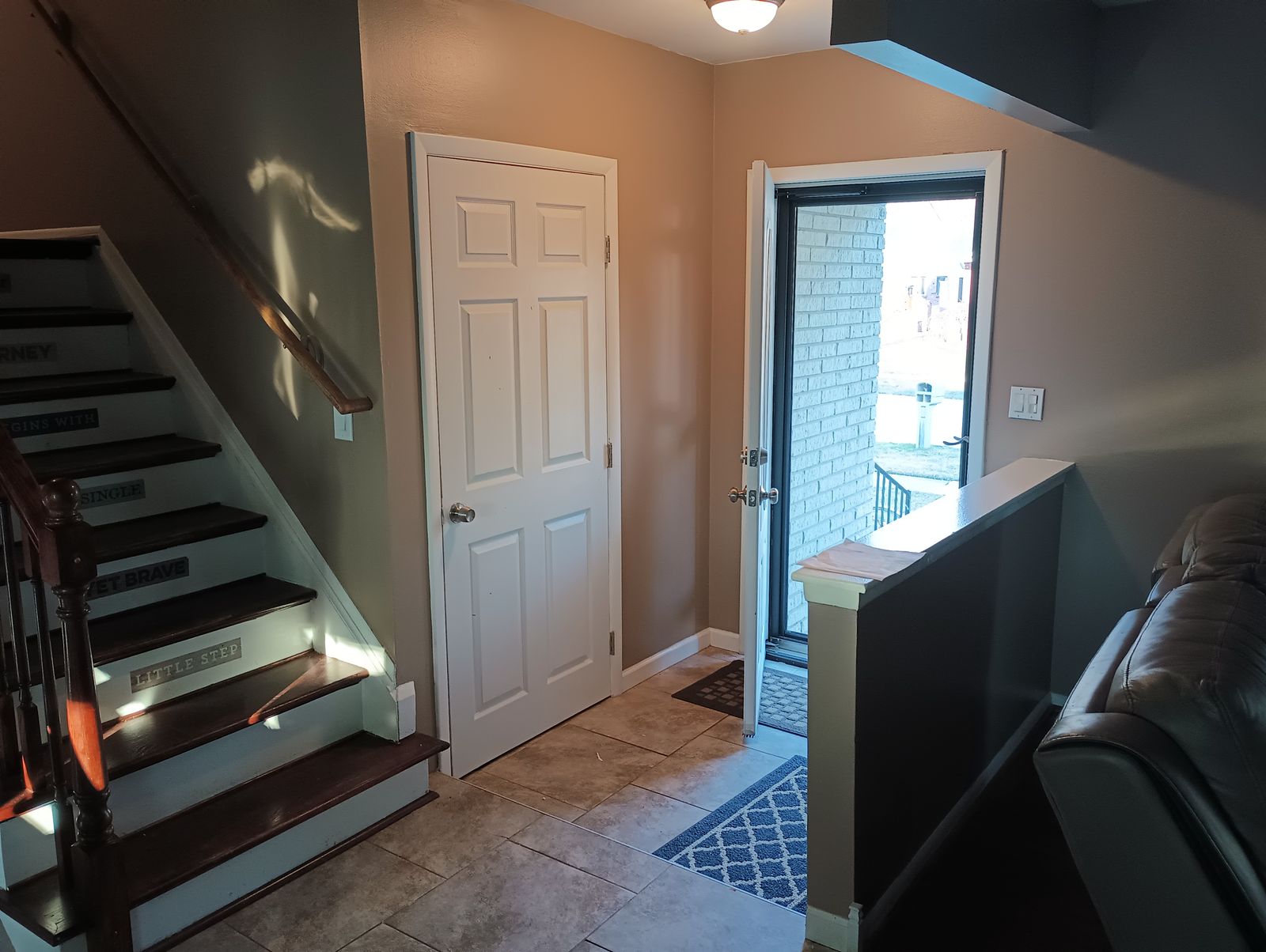 Entryway after repaint, warm tan walls and tile floor