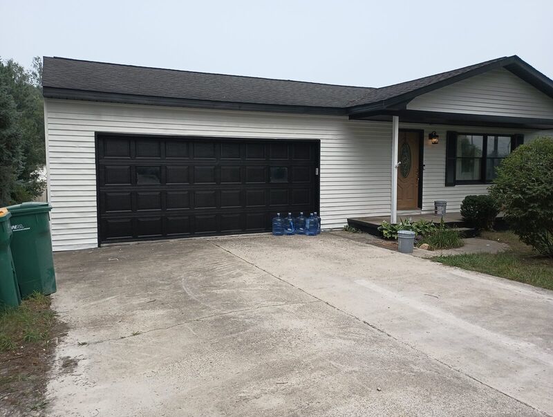 Front entry detail after repaint, black door trim and window frames
