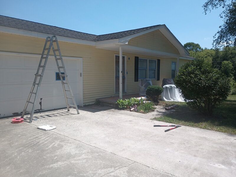 Garage door masked and taped during prep, mid-project