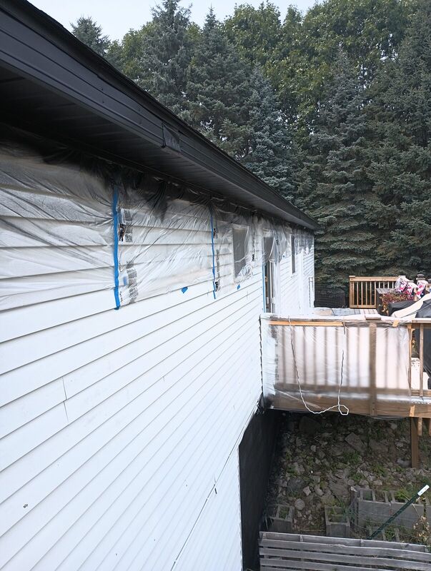 Finished side elevation, white upper siding with black block base